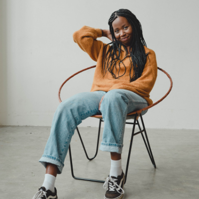 black girl sitting down and smiling 