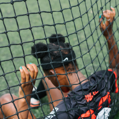 female footballer holding net 